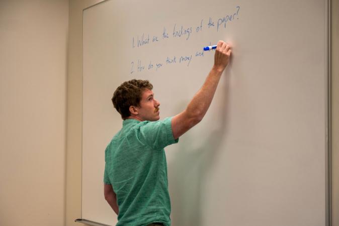 Gerard Rothfus writing in classroom